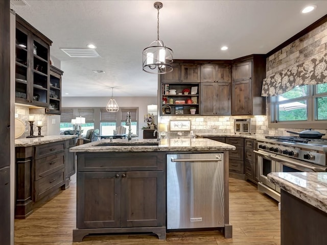 3274 Cc Rd, Diboll, TX 75941 - kitchen featuring open shelves, stainless steel appliances, dark brown cabinetry, a kitchen island, and light stone countertops