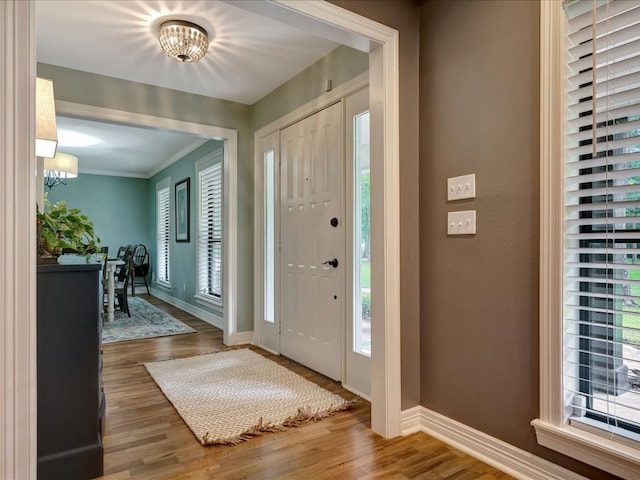 3274 Cc Rd, Diboll, TX 75941 - foyer with a chandelier, baseboards, wood finished floors, and ornamental molding