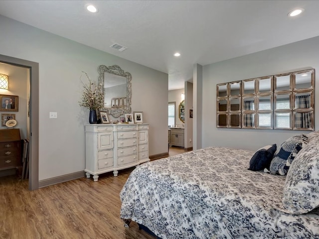 3274 Cc Rd, Diboll, TX 75941 - bedroom with wood finished floors, baseboards, recessed lighting, and connected bathroom