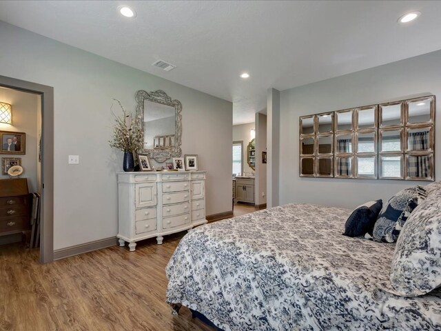 3274 Cc Rd, Diboll, TX 75941 - bedroom with wood finished floors, baseboards, recessed lighting, and connected bathroom