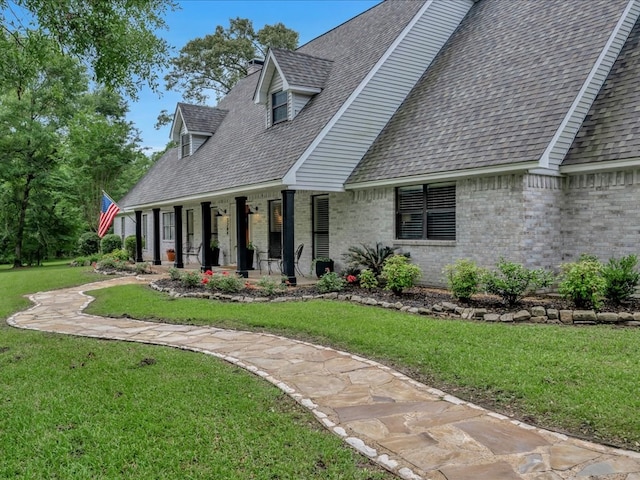3274 Cc Rd, Diboll, TX 75941 - cape cod home with a porch, a shingled roof, brick siding, and a front yard