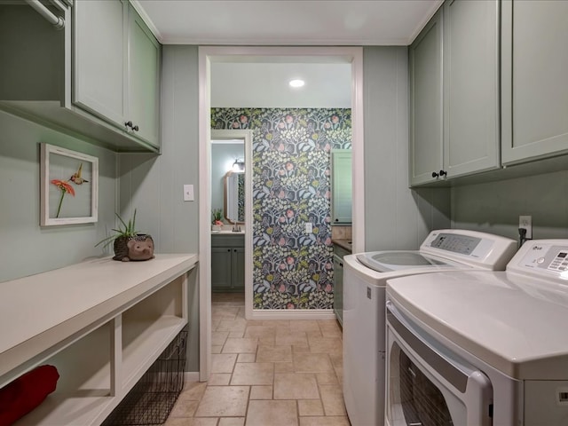 3274 Cc Rd, Diboll, TX 75941 - laundry area featuring cabinet space, wallpapered walls, washer and dryer, baseboards, and stone tile flooring