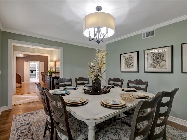 3274 Cc Rd, Diboll, TX 75941 - dining space with crown molding, wood finished floors, and baseboards
