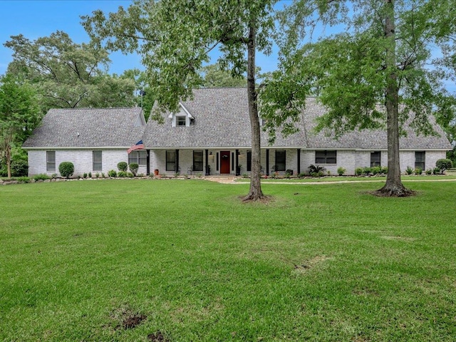3274 Cc Rd, Diboll, TX 75941 - new england style home with a front lawn, covered porch, brick siding, and a shingled roof