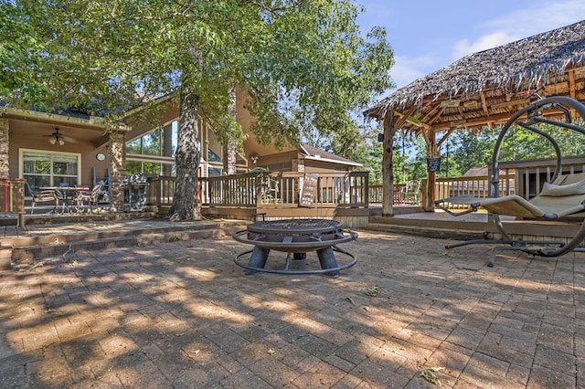 view of patio featuring a fire pit and a deck