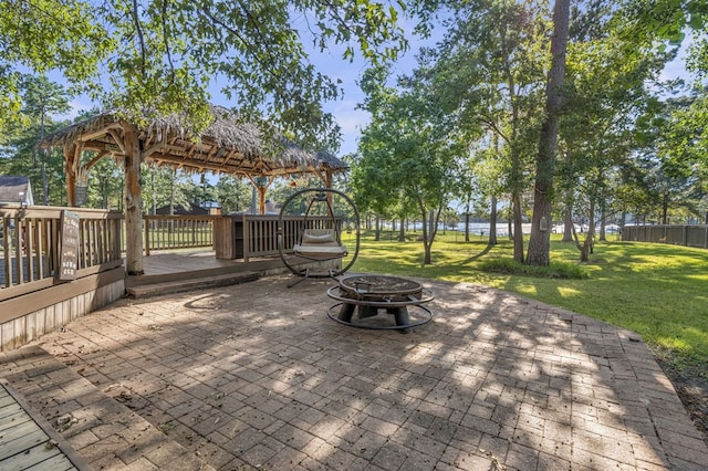 view of patio featuring a fire pit, a gazebo, and a wooden deck