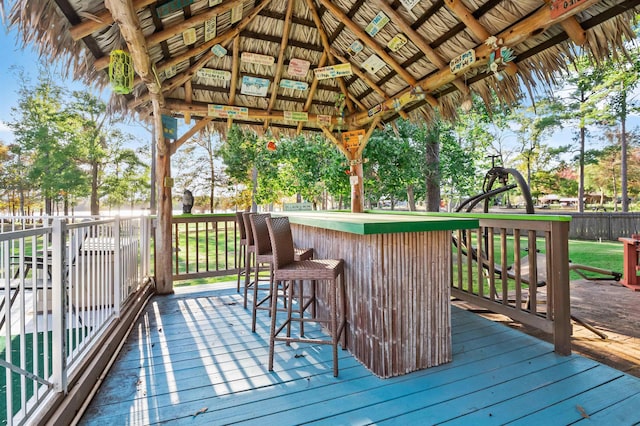 wooden terrace with a gazebo and an outdoor bar