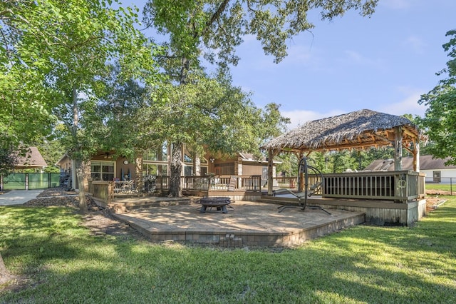 view of yard featuring a gazebo, a wooden deck, and an outdoor fire pit