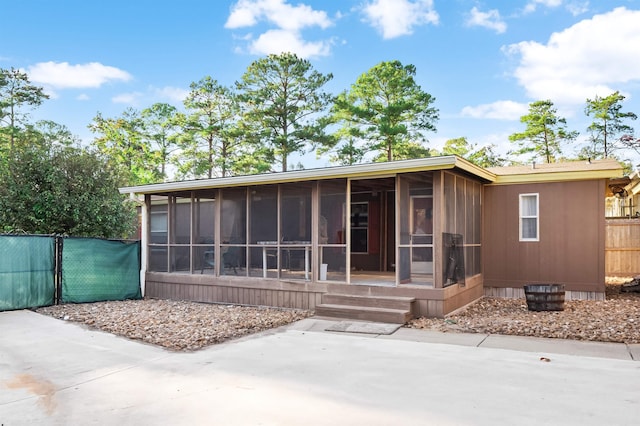 back of house featuring a sunroom