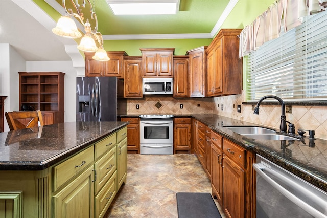 kitchen featuring tasteful backsplash, sink, pendant lighting, and appliances with stainless steel finishes