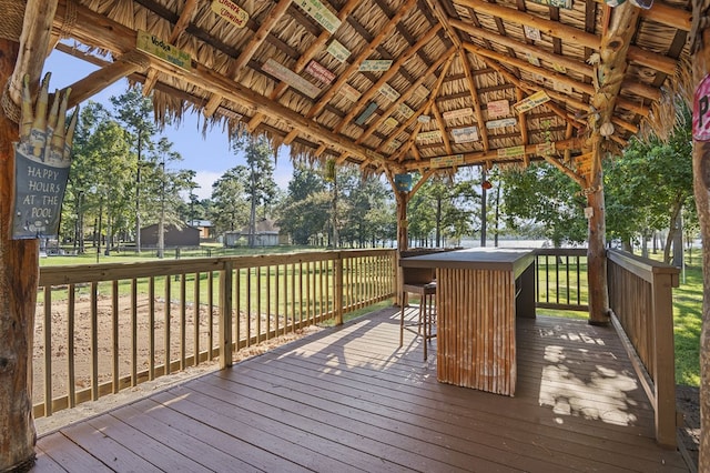 wooden terrace with a gazebo and a lawn