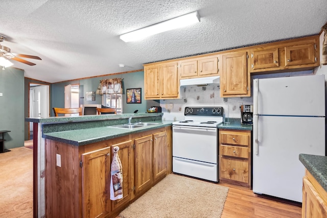 kitchen with kitchen peninsula, sink, white appliances, and light wood-type flooring