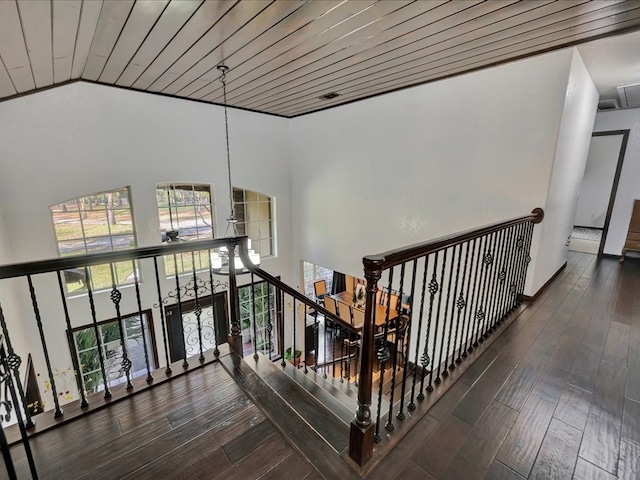 hall with dark hardwood / wood-style floors, wood ceiling, and high vaulted ceiling