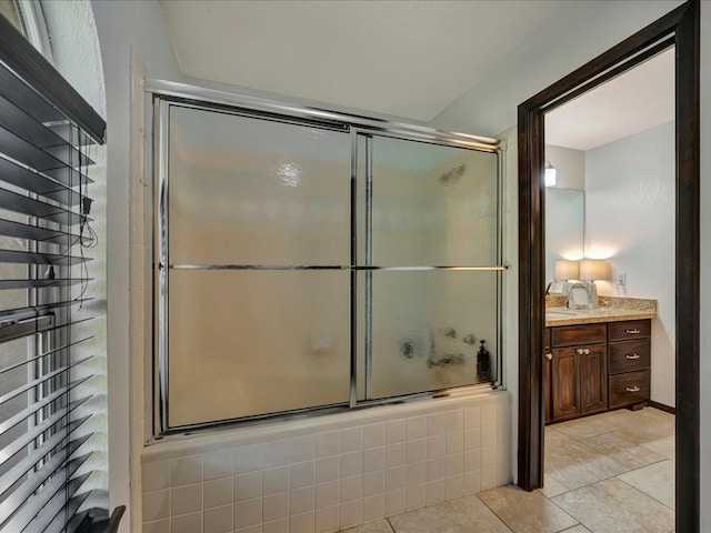 bathroom featuring tile patterned floors, vanity, and bath / shower combo with glass door