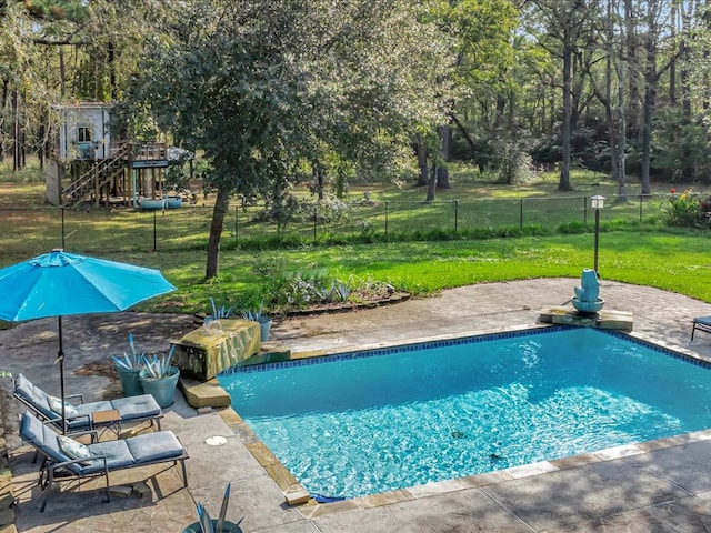 pool with a yard, a patio area, and fence