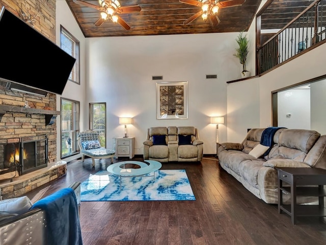 living area with visible vents, wood ceiling, hardwood / wood-style floors, a fireplace, and a ceiling fan