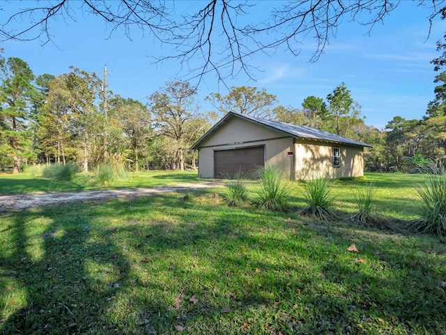 view of side of property with an outbuilding, a yard, and a garage