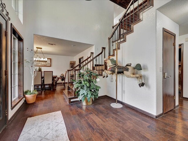 dining area featuring a textured ceiling and dark wood-type flooring