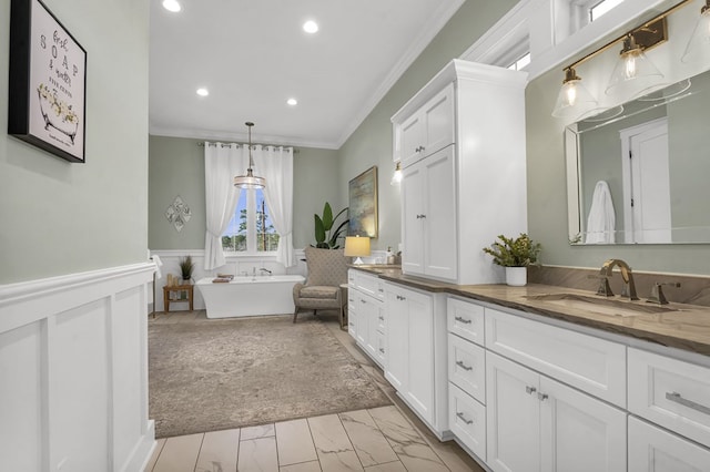 bathroom with a wainscoted wall, marble finish floor, a sink, crown molding, and double vanity