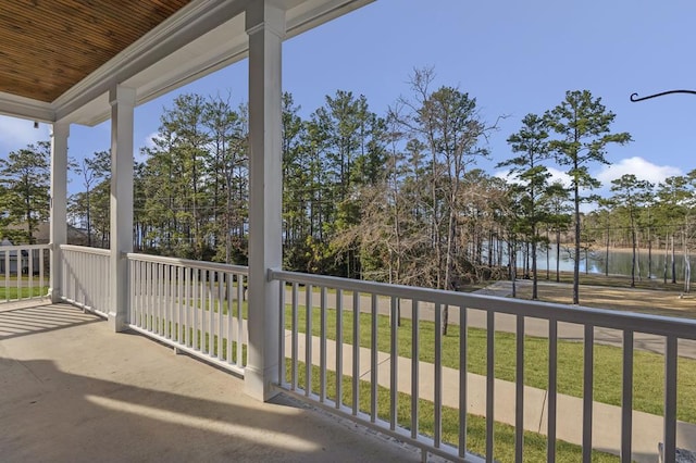 balcony featuring a water view and covered porch