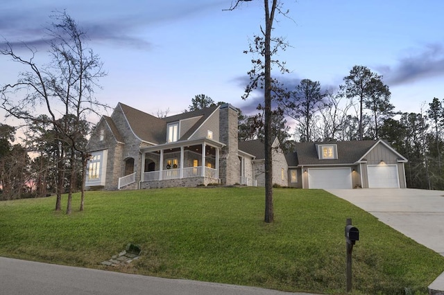 view of front of house with a lawn, driveway, a chimney, and board and batten siding