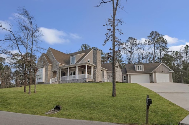 view of front of house featuring a garage, covered porch, concrete driveway, and a front yard