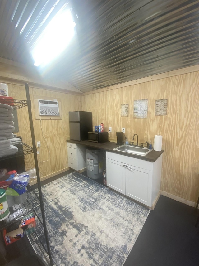 office space with a wall mounted AC, wood walls, and sink