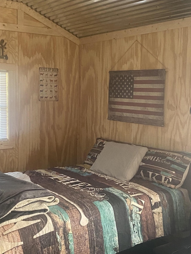 bedroom with wood walls