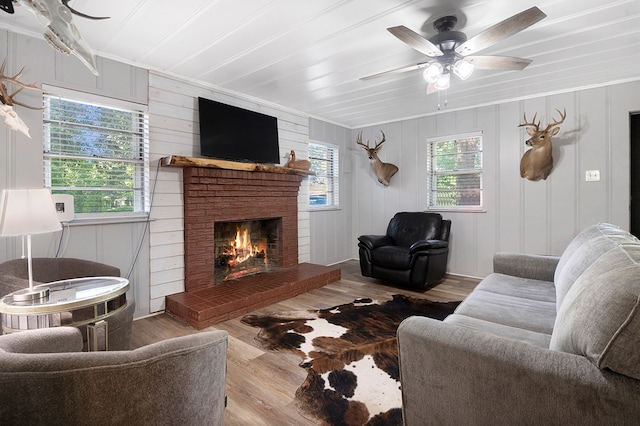 1328 Hyde Rd, Huntington, TX 74904 - living area with wood finished floors, ceiling fan, crown molding, and a brick fireplace