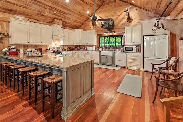 334 Pineknot Ln, Milam, TX 75959 - kitchen featuring light wood-style flooring, white appliances, a peninsula, and wooden ceiling