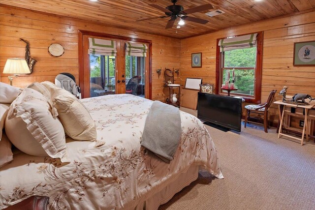 bedroom featuring ceiling fan, carpet, wood walls, and wooden ceiling