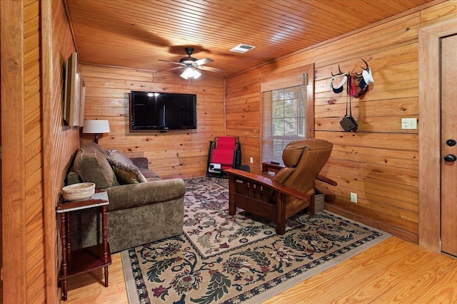 334 Pineknot Ln, Milam, TX 75959 - living room with wooden walls, wood finished floors, visible vents, ceiling fan, and wooden ceiling