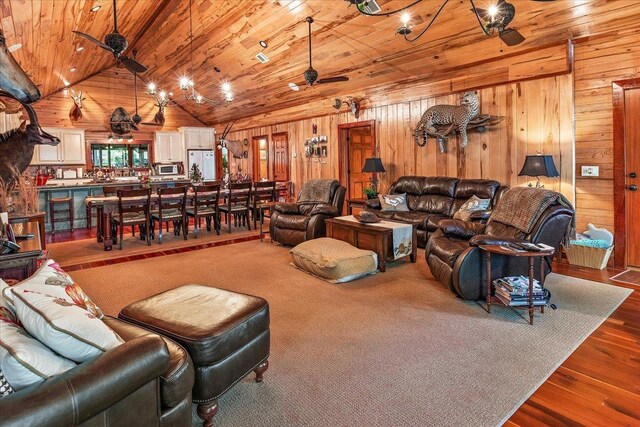 dining space featuring wooden ceiling, hardwood / wood-style flooring, wooden walls, and high vaulted ceiling