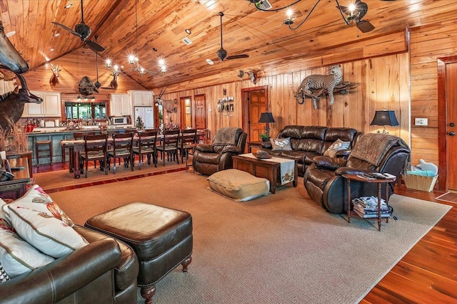 334 Pineknot Ln, Milam, TX 75959 - living area with wood walls, wooden ceiling, a ceiling fan, and vaulted ceiling