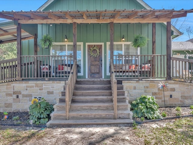 property entrance with board and batten siding and a porch