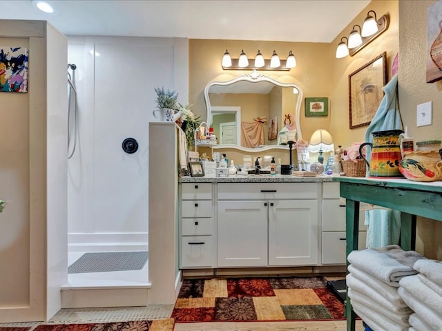 bathroom with a shower and vanity