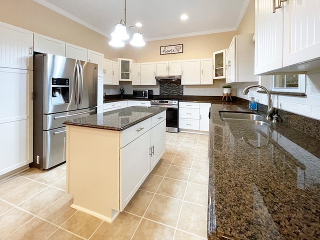 kitchen featuring stainless steel appliances, sink, a kitchen island, and white cabinets