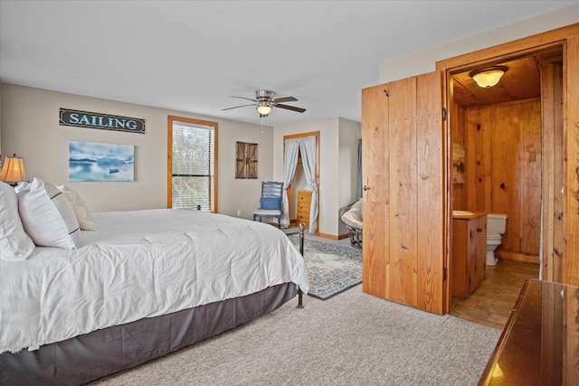 carpeted bedroom featuring ceiling fan and ensuite bathroom