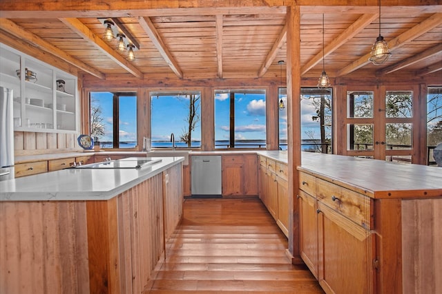 kitchen featuring light wood finished floors, wooden ceiling, beam ceiling, and appliances with stainless steel finishes