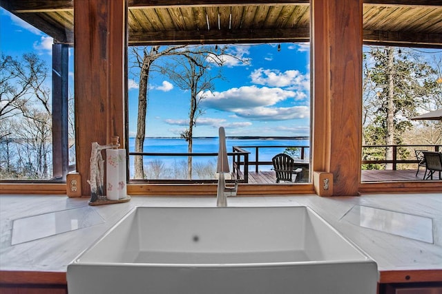 interior details featuring a sink and a water view