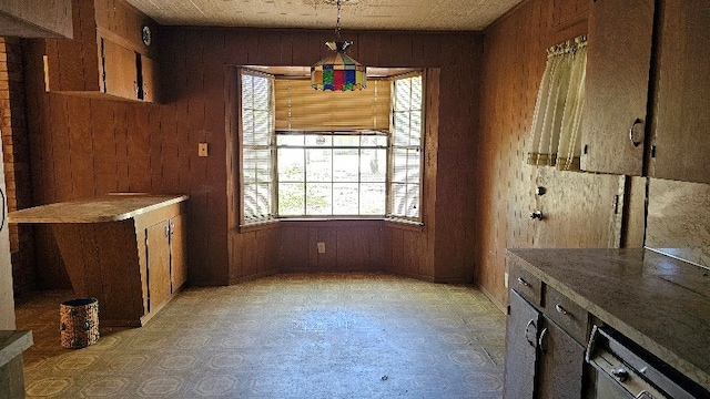 unfurnished dining area featuring wooden walls