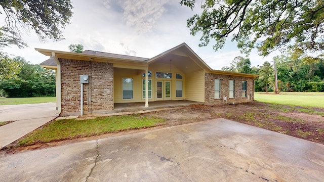 1780 County Road 293, Jasper, TX 75951 - view of front of house with brick siding and a patio