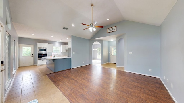 1780 County Road 293, Jasper, TX 75951 - unfurnished living room featuring arched walkways, a ceiling fan, baseboards, recessed lighting, and high vaulted ceiling