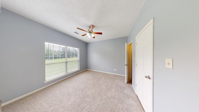 1780 County Road 293, Jasper, TX 75951 - spare room featuring a textured ceiling, a ceiling fan, light carpet, and baseboards
