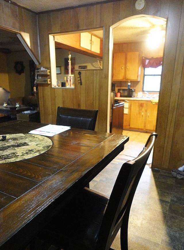 118 Jones St, Lufkin, TX 75901 - dining area featuring arched walkways and wood walls
