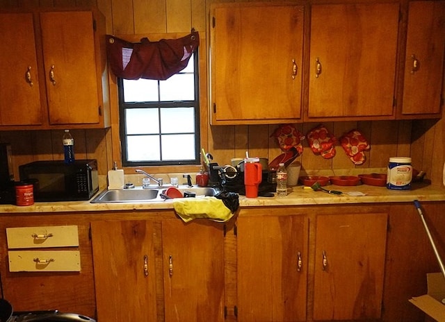 118 Jones St, Lufkin, TX 75901 - kitchen with black microwave, light countertops, and brown cabinets