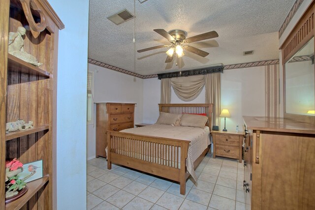 tiled bedroom featuring ceiling fan and a textured ceiling