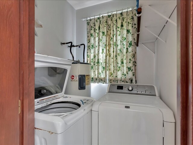 laundry area featuring electric water heater and washing machine and dryer