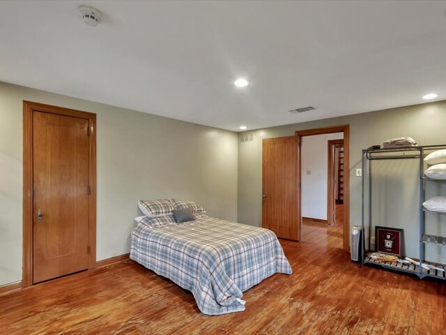 bedroom with hardwood / wood-style floors