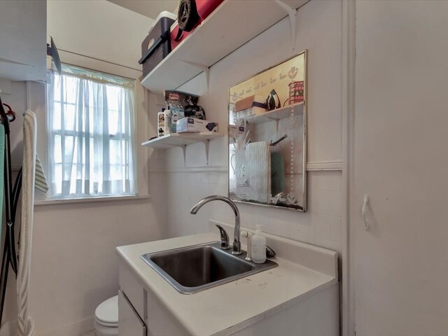 kitchen featuring white cabinetry and sink